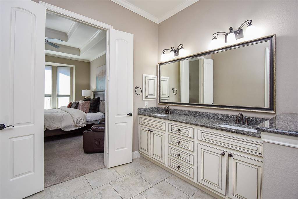 Custom painted cabinetry throughout the home with granite countertops for consistent, elegant finishes.