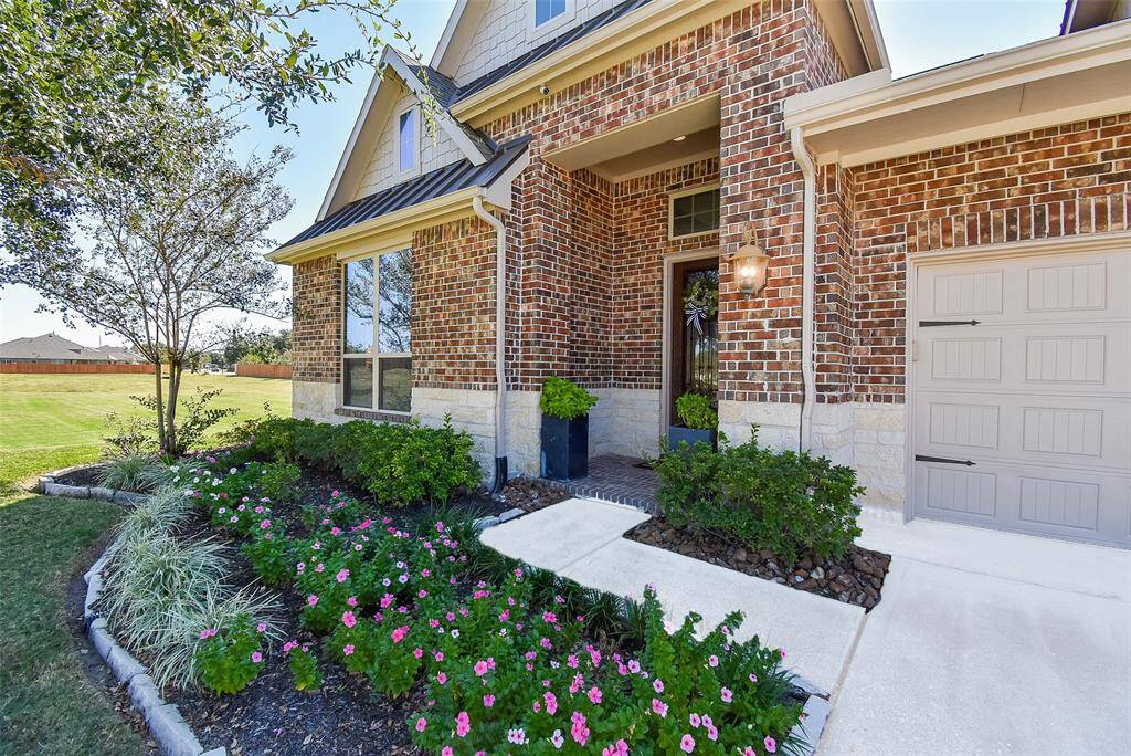 Attractive front elevation with stone accent and metal roofing details.