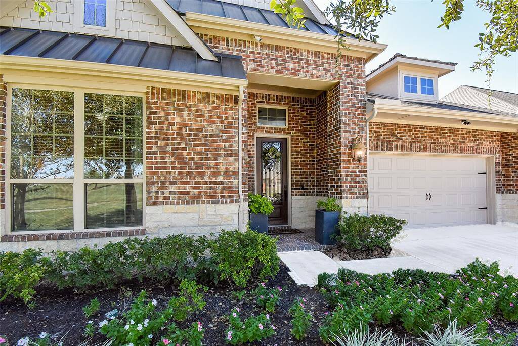 Double-wide driveway and nicely appointed front covered porch entry.