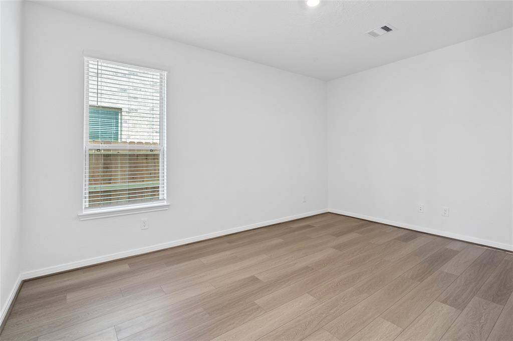 Quietly nestled in front of the home is the handsome Den! Featuring gorgeous vinyl plank flooring, high ceilings, large window with privacy blinds and custom paint!