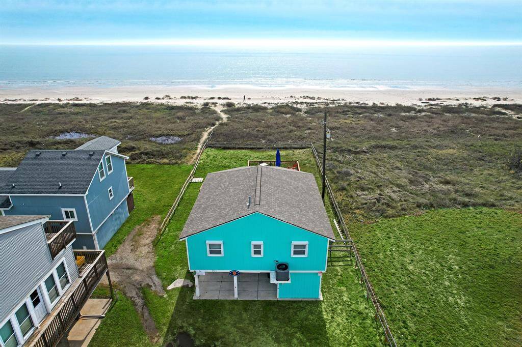 AERIAL VIEW FROM THE FRONT OF HOUSE. THIS HOME OFFERS A WONDERFUL BEACH VIEW, A PERFECT PLACE TO LISTEN TO THE SOOTHING WAVES.