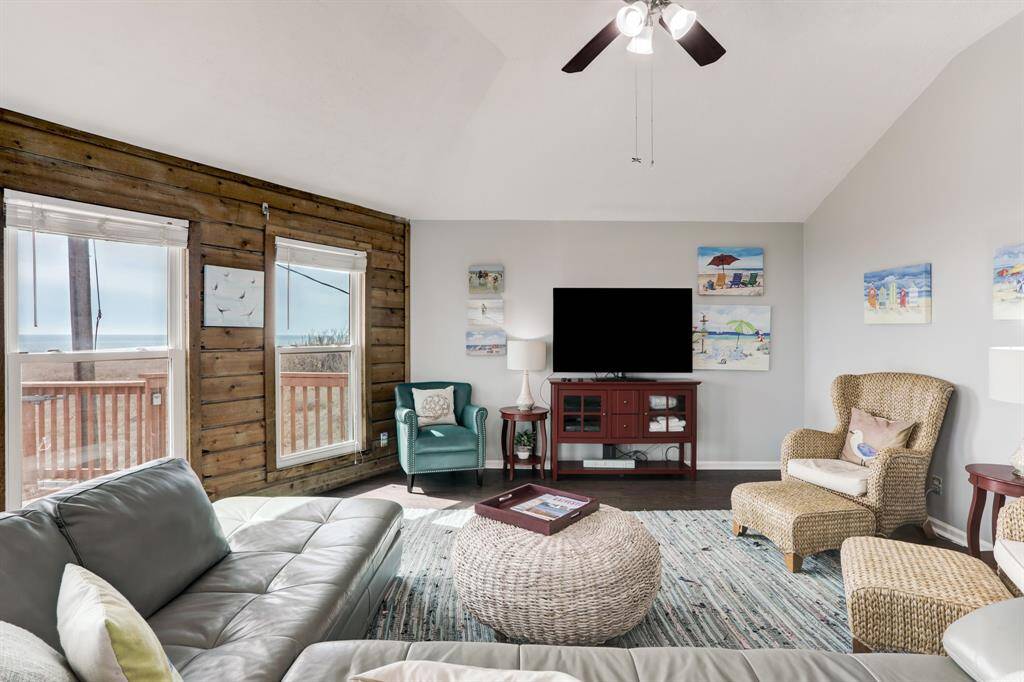 THE LIVING AREA IS SPACIOUS AND OPEN WITH A GLOW OF NATURAL LIGHT.