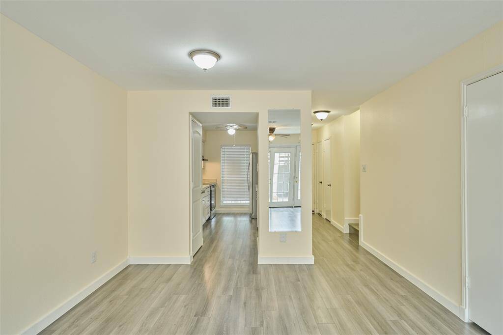 Inviting kitchen with sleek flooring and ample natural light.
