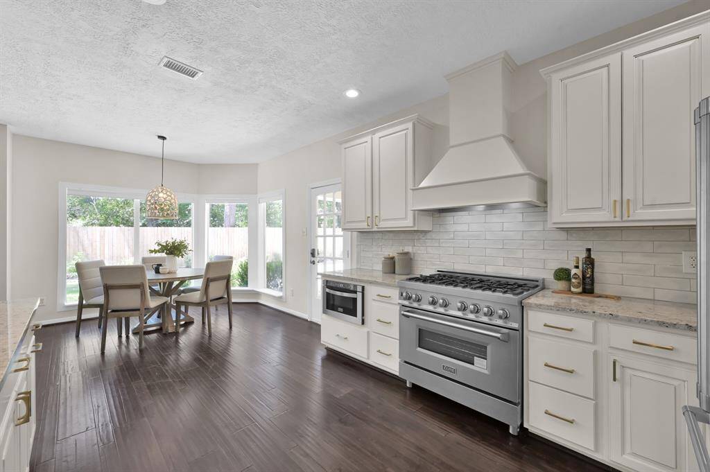An entertainer’s dream—this gourmet kitchen pairs high-end appliances with custom cabinetry and flows effortlessly into the light-filled breakfast room overlooking the backyard.