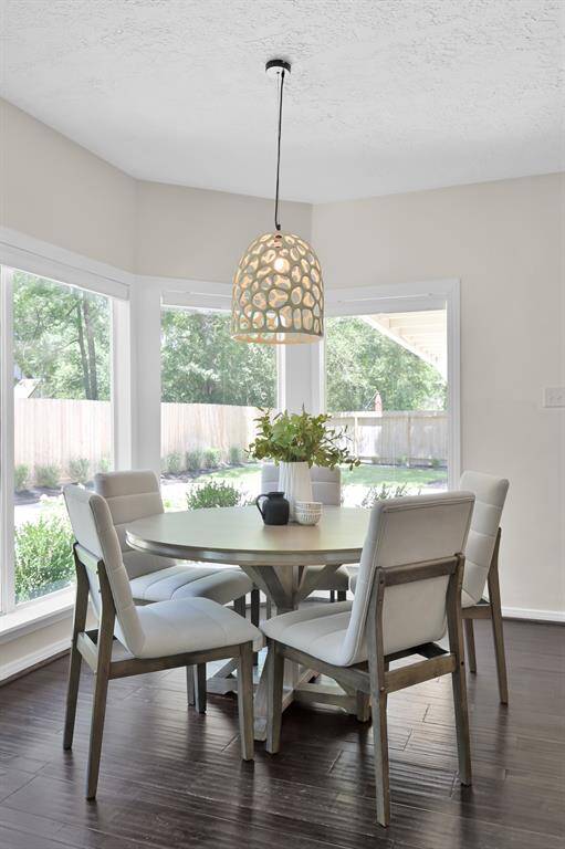 With panoramic backyard views and a statement light fixture above, this intimate dining nook blends warmth, elegance, and natural light for everyday luxury.