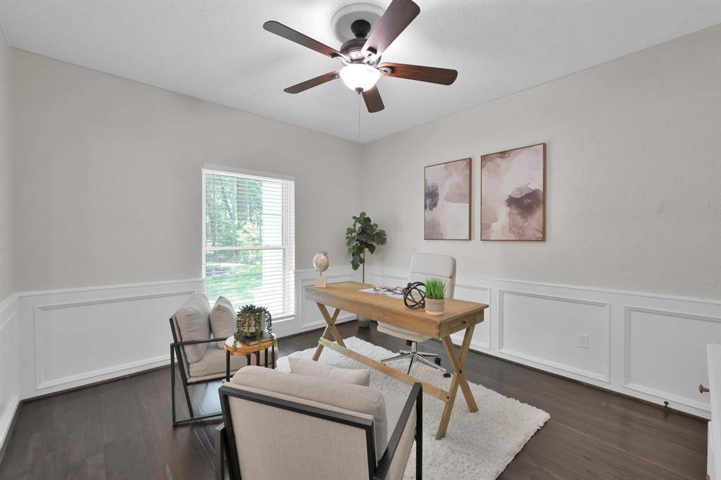 This luxurious flex space effortlessly functions as a formal study, reading room, or executive office—complete with rich floors, custom wainscoting, and sun-drenched serenity.