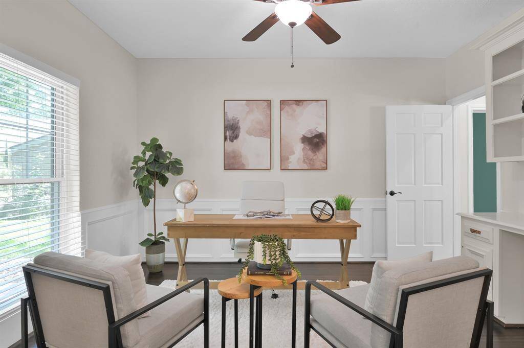 A sophisticated setting framed by serene views and custom cabinetry—this light-filled flex space offers the perfect balance of beauty and function.