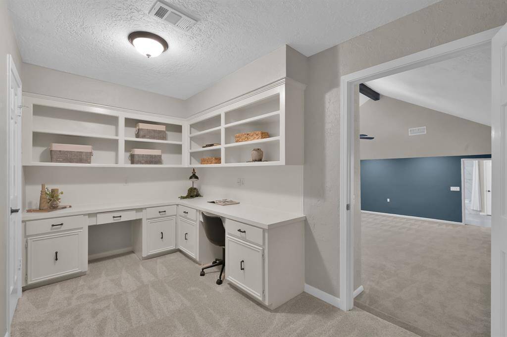Tucked within the private guest quarters, this built-in study nook features custom cabinetry, abundant shelving, and a dedicated workspace—perfect for remote work, reading, or creative pursuits in quiet comfort.