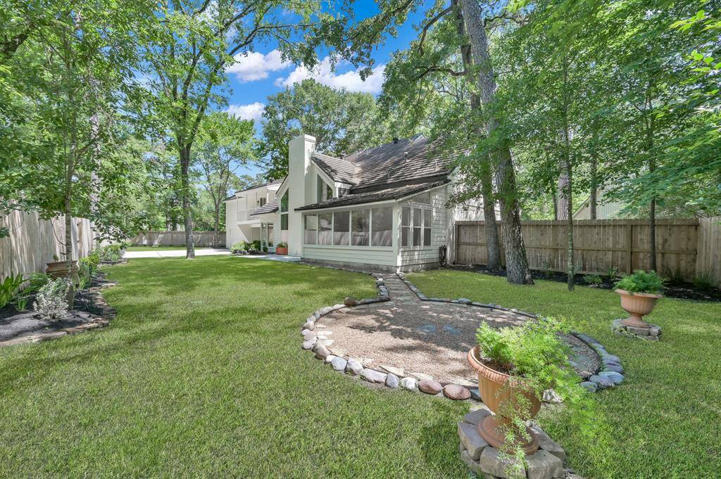 Surrounded by mature trees and lush landscaping, the expansive backyard offers a tranquil escape with ample green space for play, entertaining, or future outdoor enhancements.