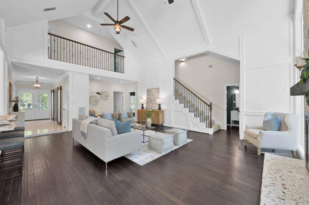 Thoughtfully designed for both grand entertaining and relaxed everyday living, this dramatic open-concept space showcases soaring ceilings, a striking staircase, and impeccable architectural detail.