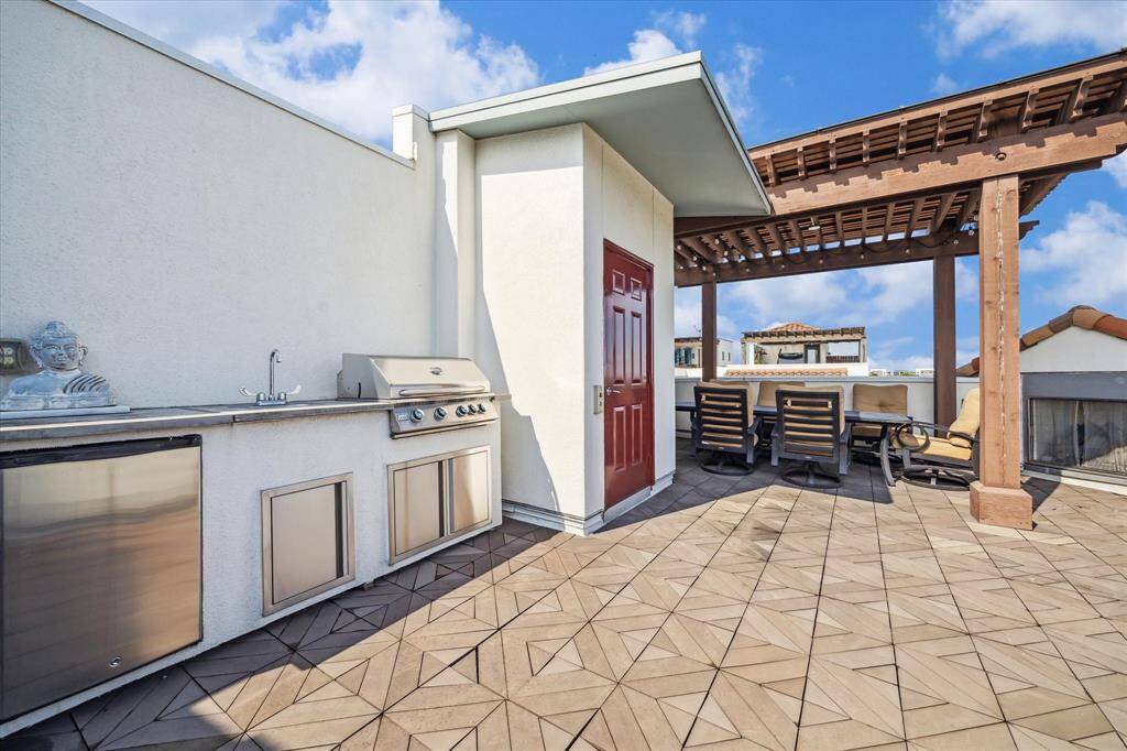 A full outdoor kitchen, including a sink and refrigerator, provide a perfect spot for entertaining.