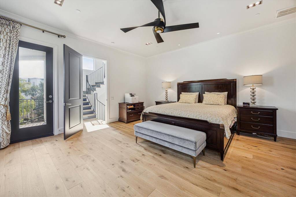 The third floor is dedicated to a luxurious and spacious primary suite with balcony.  Plenty of room for seating or an office area.