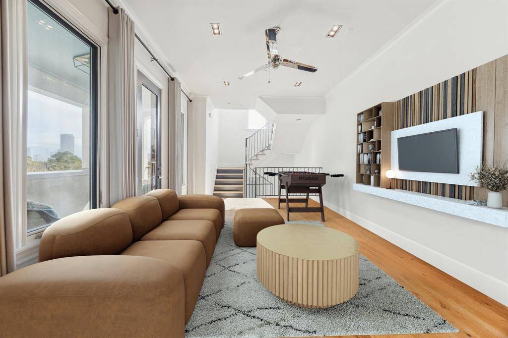 On the fourth floor you are greeted with a large flex space and expansive balcony.  The flex space can be used as an office, game room or even provide extra sleeping space!  Photo has been virtually staged.