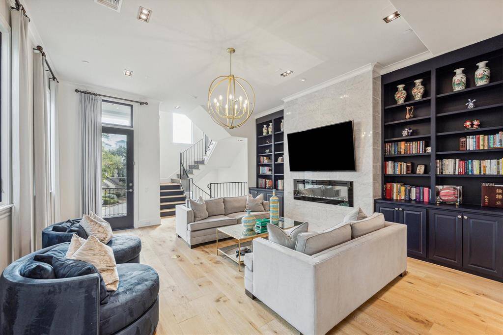 Luxurious custom drapes adorn each window. Need some fresh air, step out onto the balcony with sunny views! Each level of the home has a balcony to enjoy the unobstructed city views.