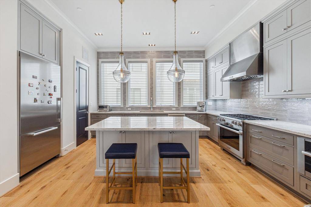 A kitchen any cook will love! Miele appliances, including a 6-burner freestanding gas stove and a separate multifunction oven make this kitchen a joy to cook in. Multiple pantries provide plenty of storage and electric shades provide ease and convenience.