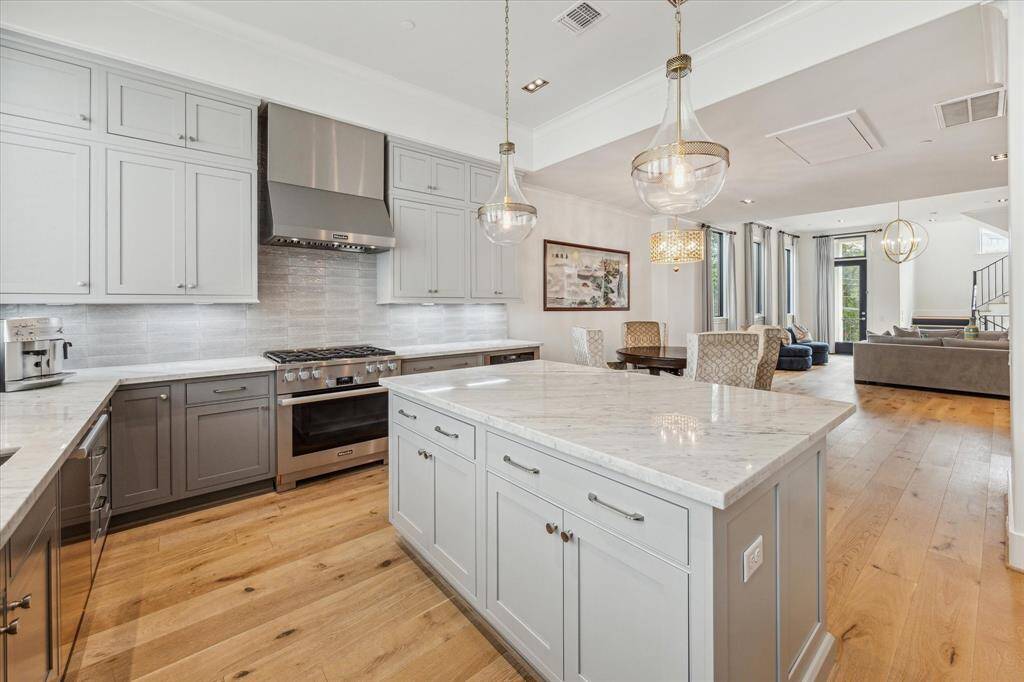 Stunning marble countertops, lighting and cabinetry that extends to the ceiling, give the kitchen an air of elegance and sophistication.