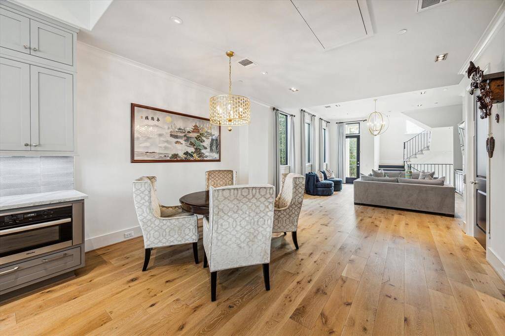 A spacious dining area provides the perfect setting for entertaining.  Elegant coordinating light fixtures give the home's decor a cohesive and elevated look.