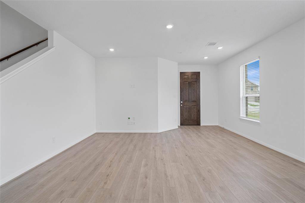 Gather the family and guests together in your lovely family room! Featuring high ceilings, recessed lighting, custom paint, gorgeous vinyl plank floors and large windows that provide plenty of natural lighting throughout the day.