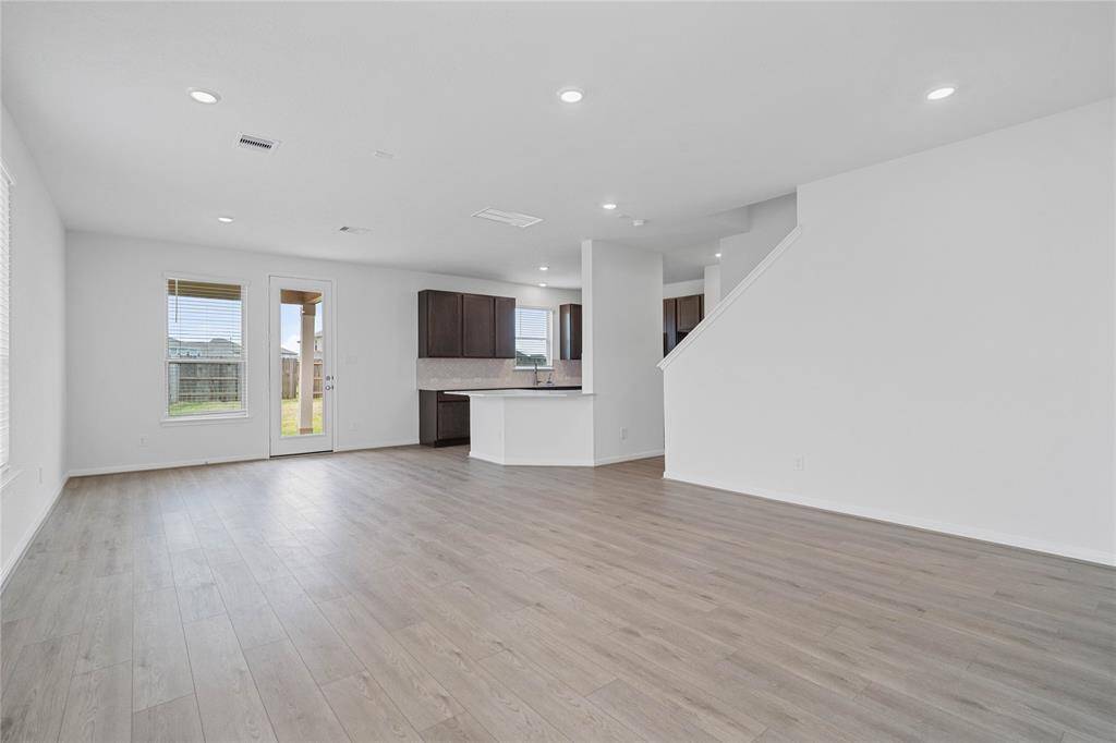 The open concept great room, dining and kitchen makes for a impressive way to keep the party going and never miss a beat! The Great Room features large windows, 2" faux wood blinds, high ceilings, recessed lighting, and Layton Lake Vinyl Plank flooring!