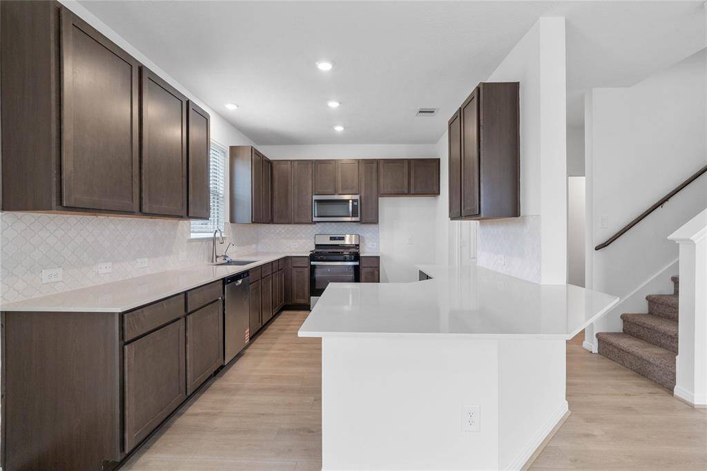 Additional view of this spacious kitchen and staircase leading to the second floor!