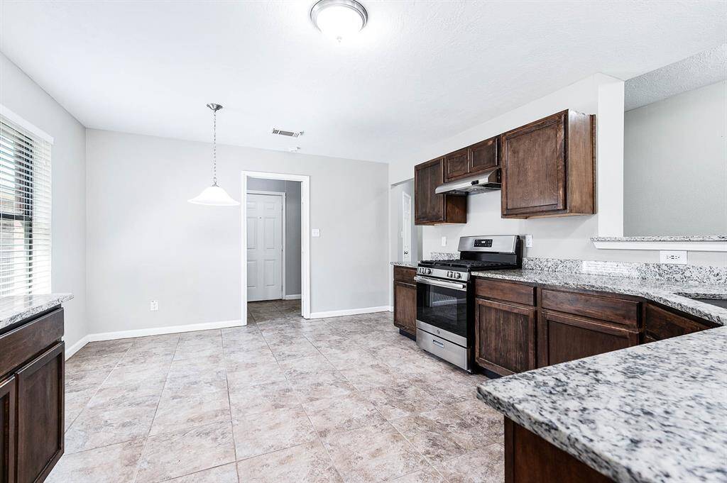 Beautiful wood cabinets for storage and granite countertops.