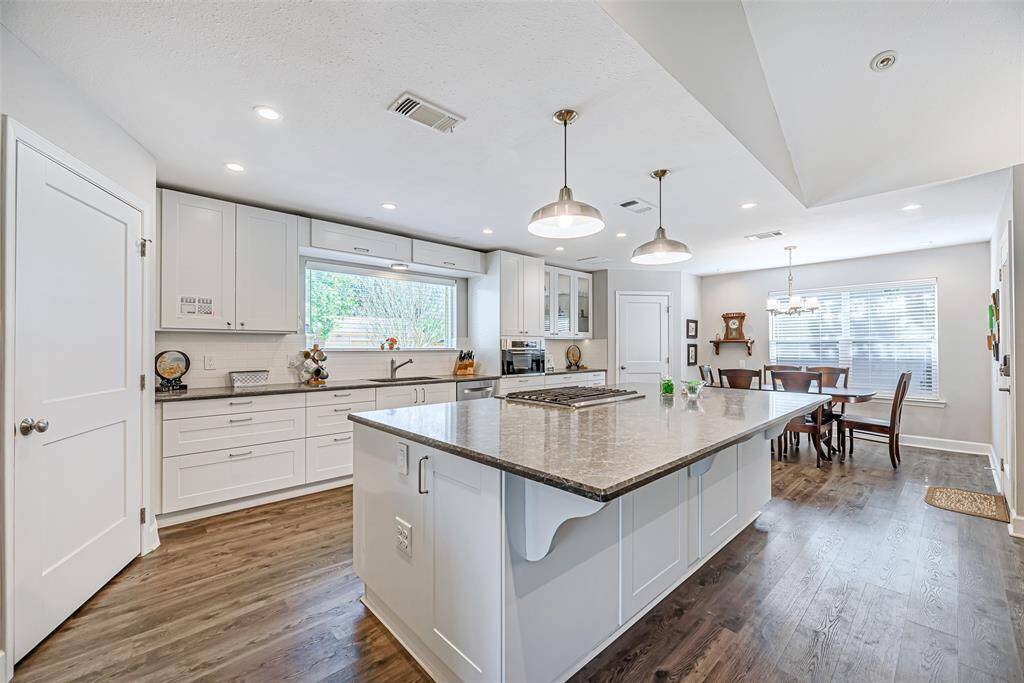 Kitchen features custom shaker style cabinets, glass front cabinets, pull out cabinets and soft close drawers.