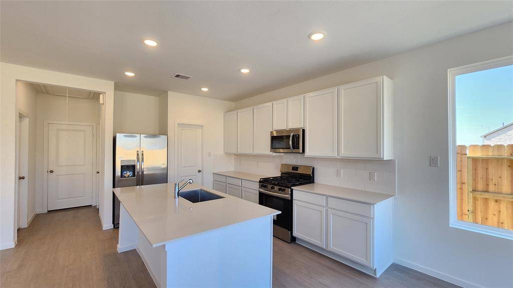 Kitchen to in-house laundry room on left and garage