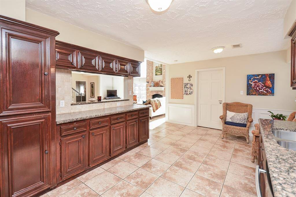The kitchen overlooks the den.