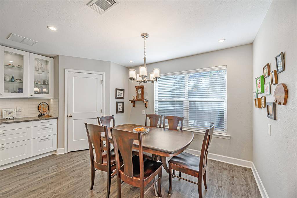 Breakfast room features canned lighting and lvp flooring as well as large picture window.