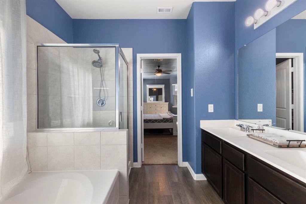 After a long day, relax in the soaking tub or large shower with tile surround and glass enclosure.