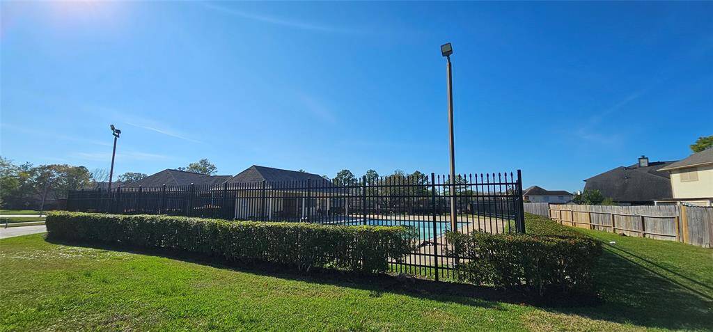 Fenced community pool located near the property.