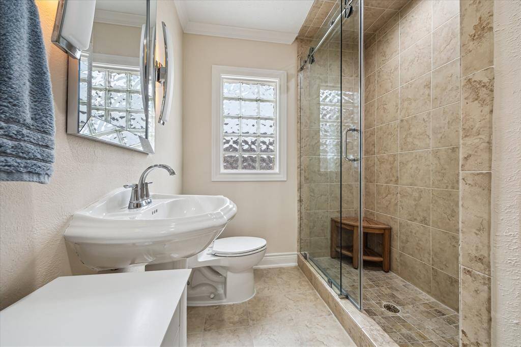 Hall Bath Serving Your Guests and for The Secondary Bedroom. This Full Bath has A Huge Walk-In Shower Note the Amazing Barn Door Like Shower Door. Lights over the Sink Have a Soft Light Mode Also.