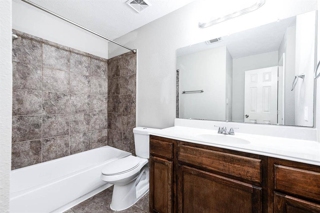 Secondary full bathroom featuring a tub shower combo