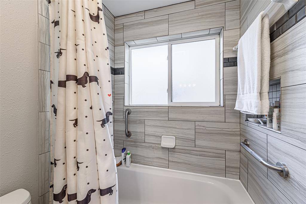 Primary bathroom has a large tub shower combo.