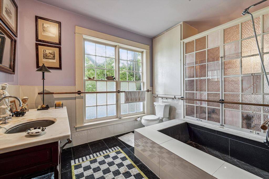 Second primary bathroom with tile floors, single sink and a show/tub combo.