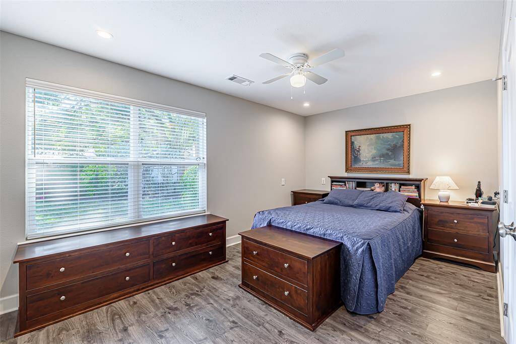 Secondary bedroom features lvp flooring, canned lighting and ceiling fan.