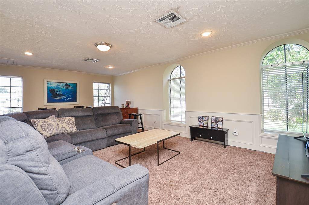 At the top of the stairs is the game room.  It overlooks the den and is large enough for this oversized reclining sectional and a game table, too.