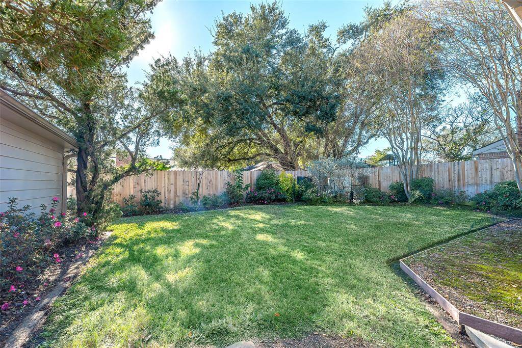 Landscaping continues into the backyard of the home.