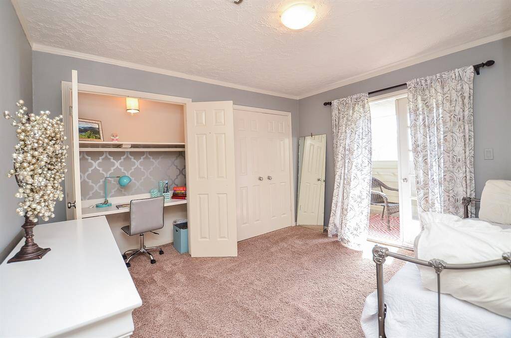 Upstairs bedroom #1 has a built in study area and a sliding glass door to a private balcony.