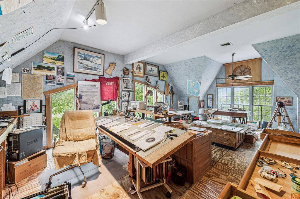Office with wood floors, track lighting and ceiling fan.