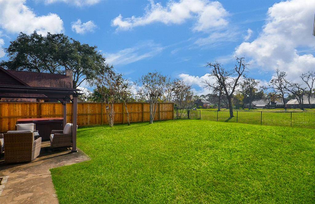 The patio and the large, pool-sized backyard.