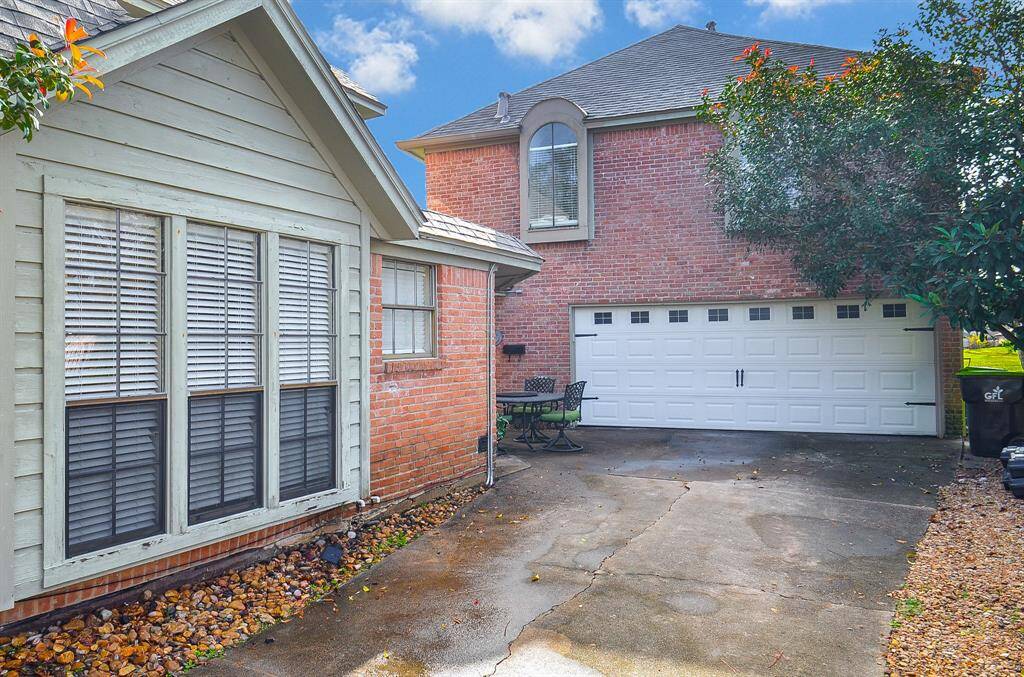 To the left of the double garage door is a private entrance to the apartment above the garage.