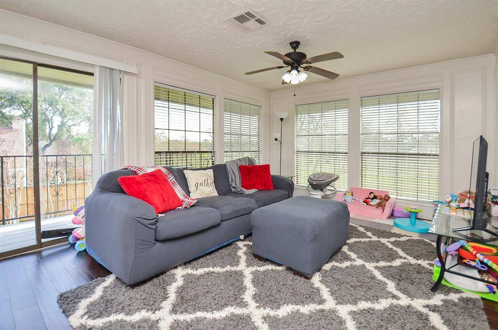 The living area of the apartment is light and bright and has floor to ceiling windows on two sides.