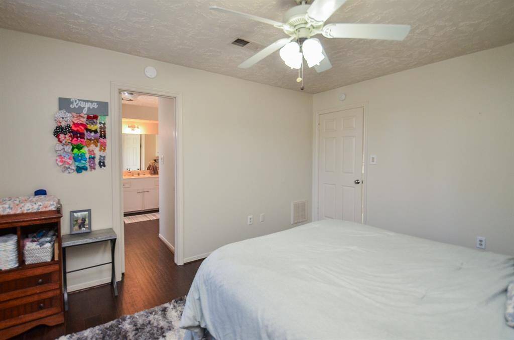 Another view of the bedroom with the door to the full bath.