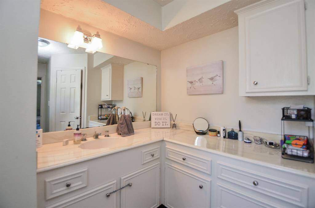 The bathroom is spacious with plenty of storage.