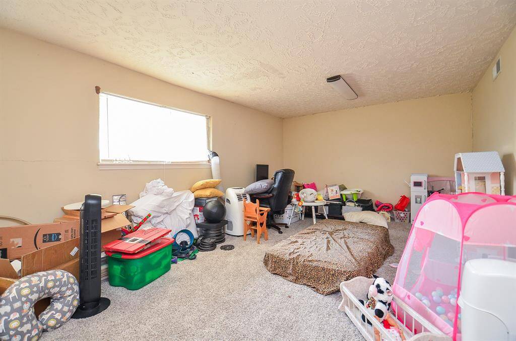 Behind the garage bays, on the first floor, and attached to the apartment is a flex room.  It is currently being used as climate controlled storage.  It has a door to the backyard and also direct access to the apartment area.  It would make a great game room or another home office.