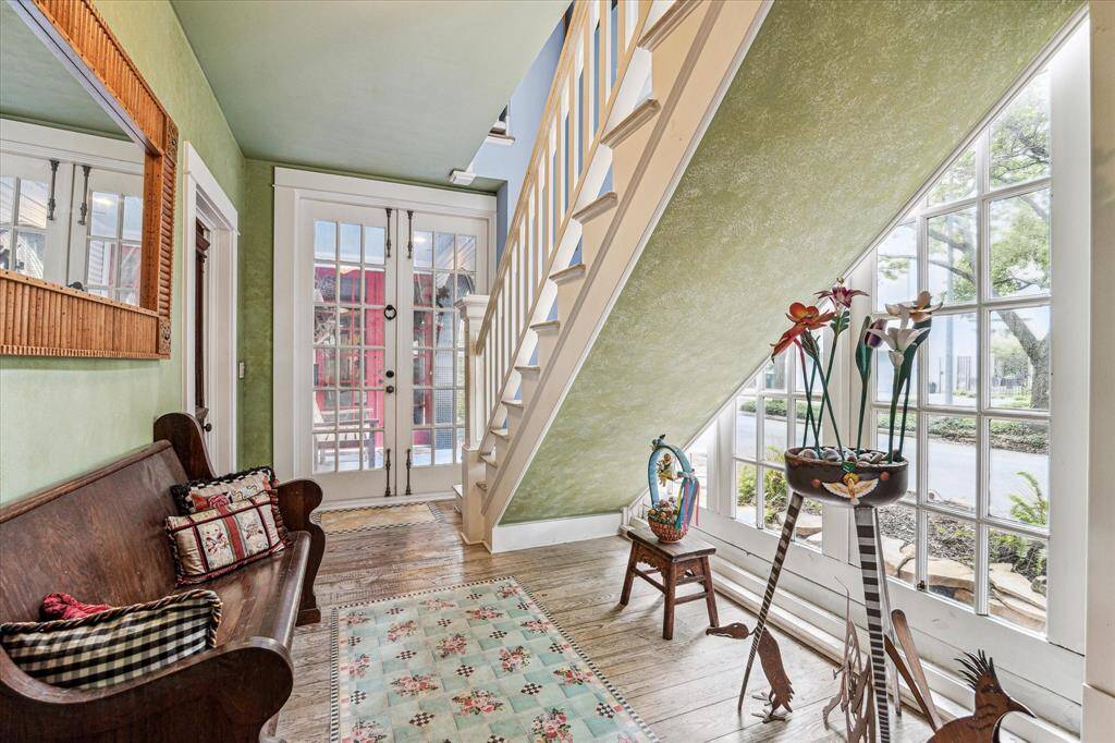 Entry with double doors, wood floors and wonderful natural light.