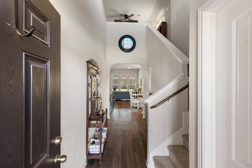 As you enter the home, you are greeted with warm vinyl flooring, neutral paint, and soaring ceilings.  The hints of architectural detail and abundance of natural light will not disappoint.