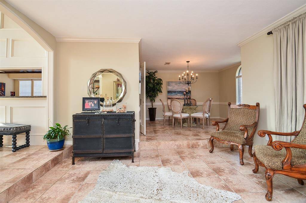 On the right of the entry is the front living area and the dining are beyond.  To the left it is open to the den.