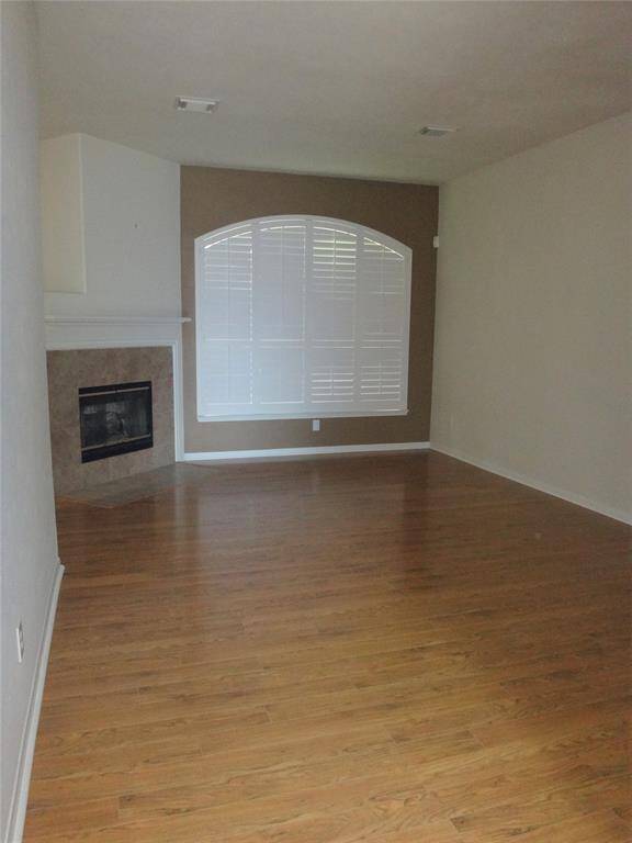 Living room has plantation shutters and a dual sided fire place.